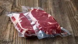 Wide image of steak in sealed plastic bag prepped for sous vide.
