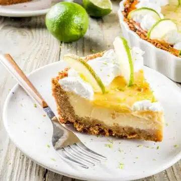 Wide close up image of a slice of key lime pie.