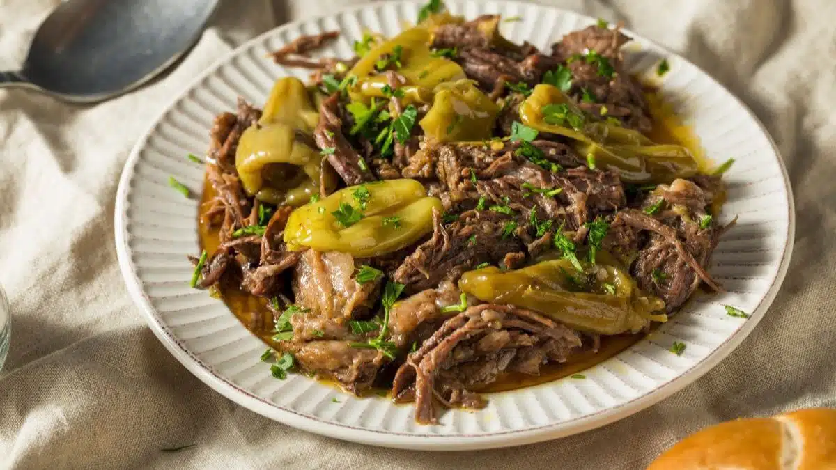 Wide image of Mississippi pot roast on a white plate.
