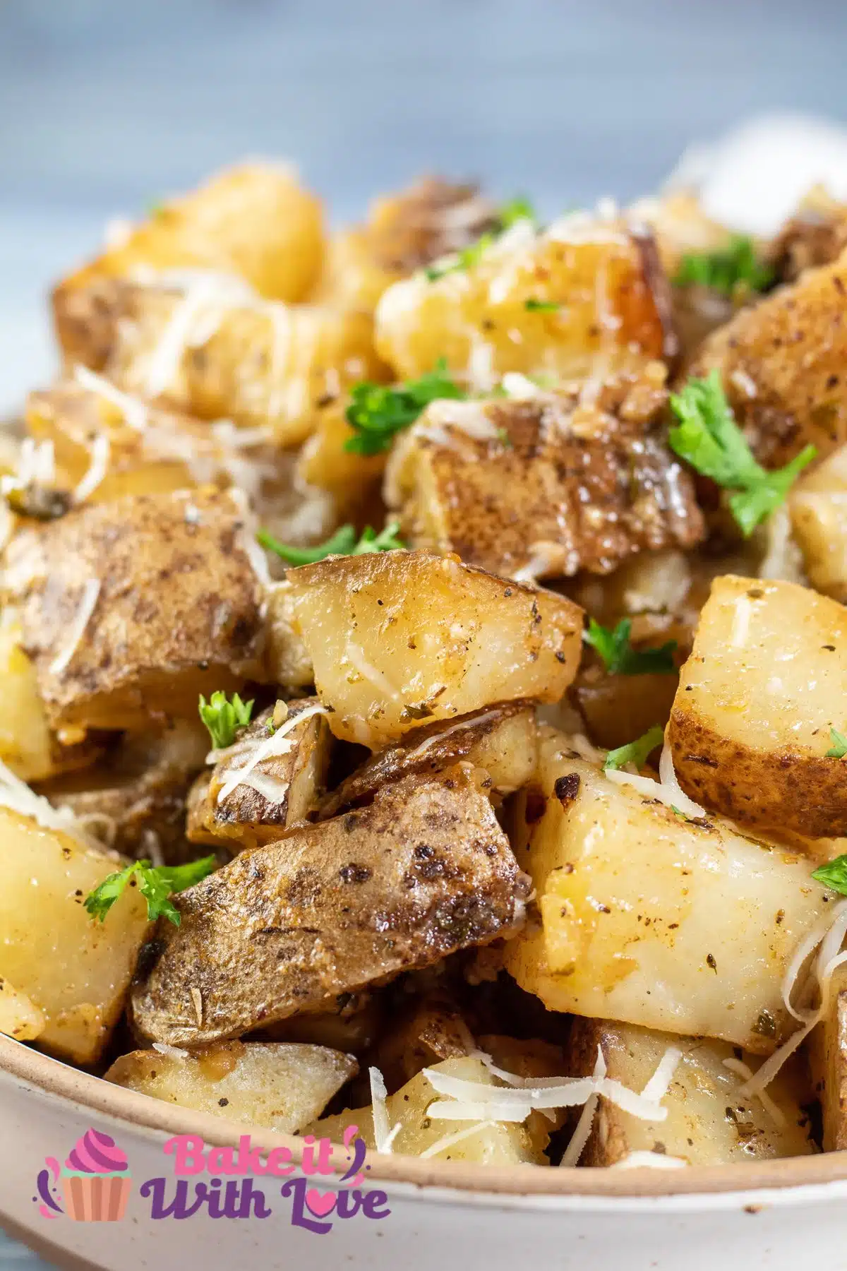 Tall image of slow cooker roasted potatoes in a bowl.