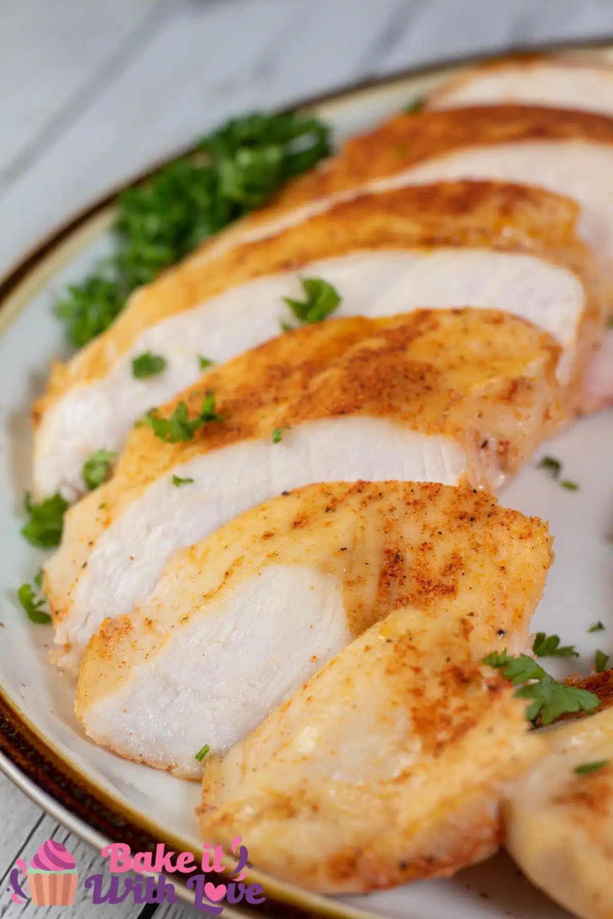 Tall image showing sliced sous vide boneless skinless chicken breast.