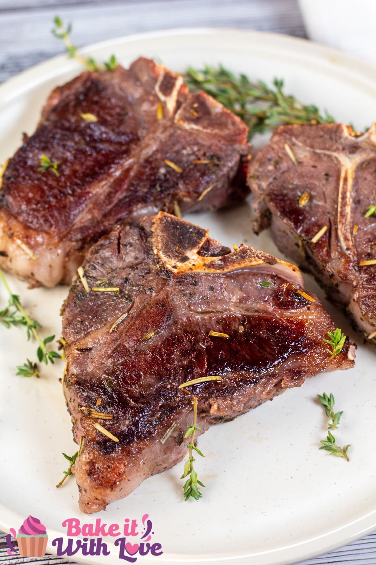 Tall image showing sous vide lamb chops on a white plate.