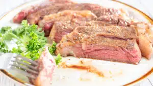 Wide image of sliced sous vide ribeye steak.