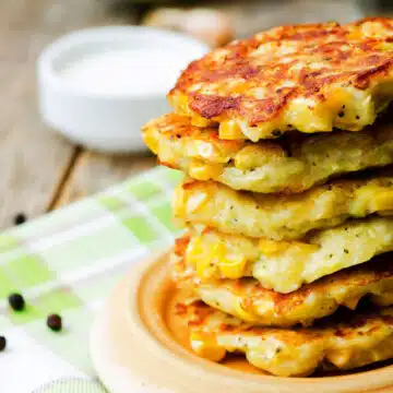 Wide image of a stack of Southern corn fritters.