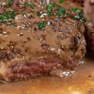 Wide image showing steak au poivre.