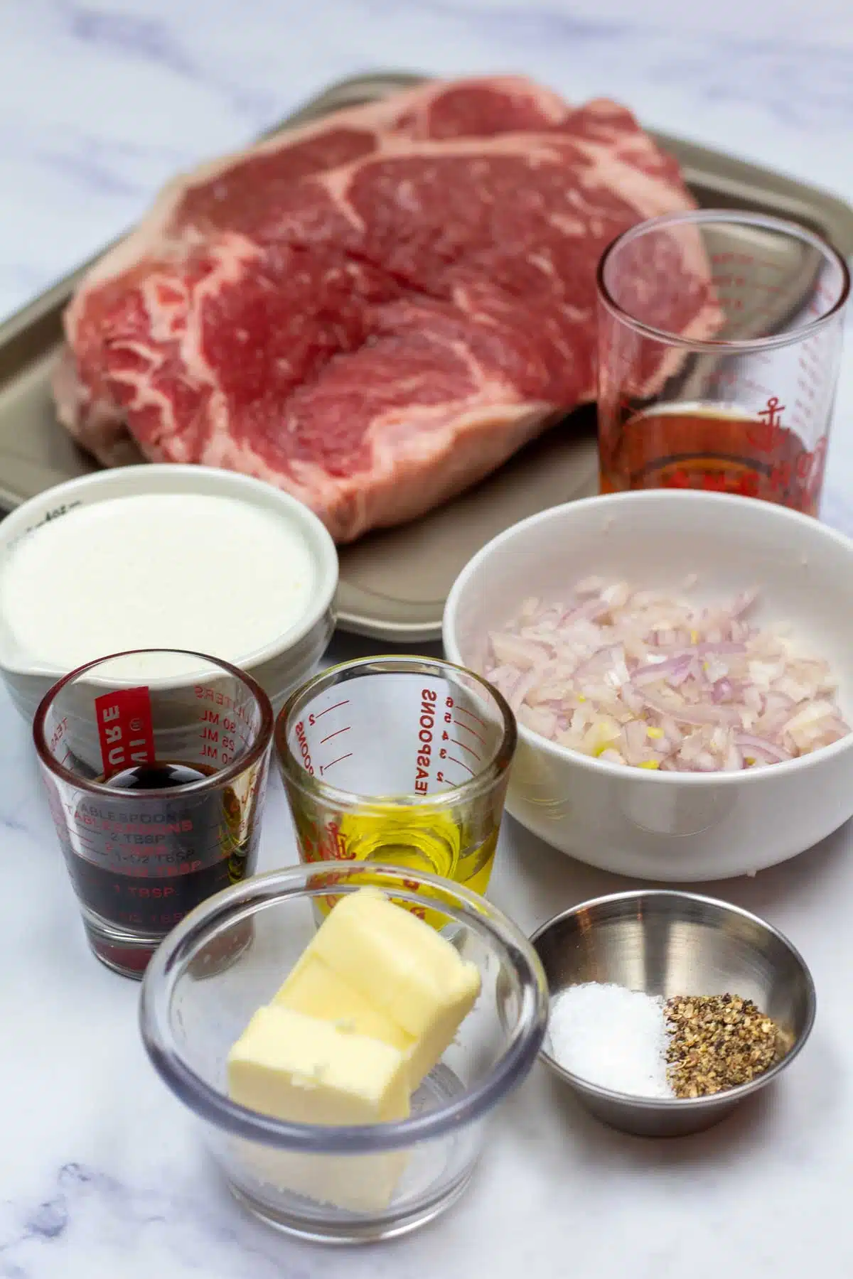 Tall image of steak au poivre ingredients.