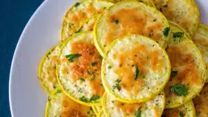 Wide image showing baked Parmesan yellow squash.