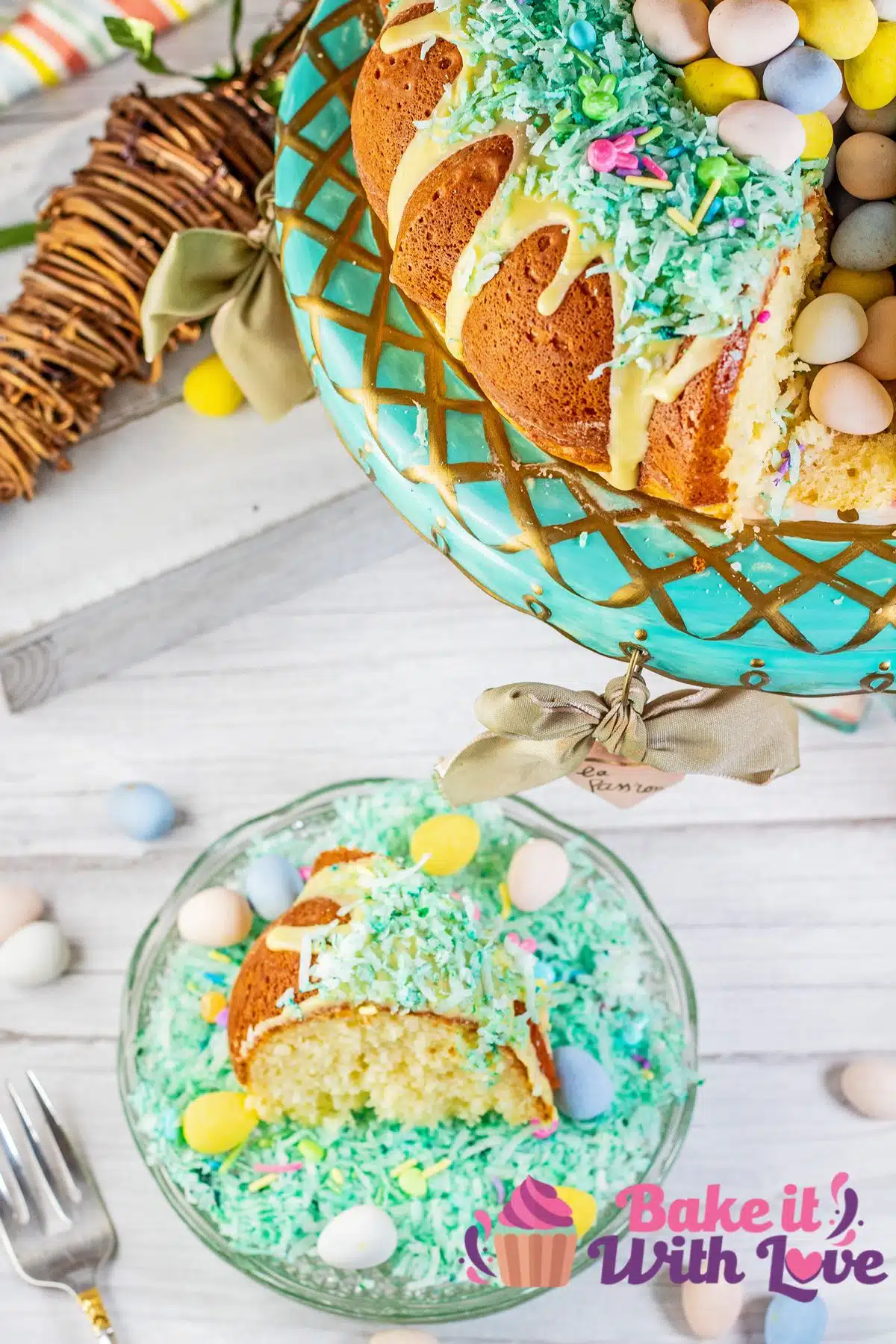Easter mini egg cake sliced and served on clear glass plate in a bed of the green colored shredded sweetened coconut.