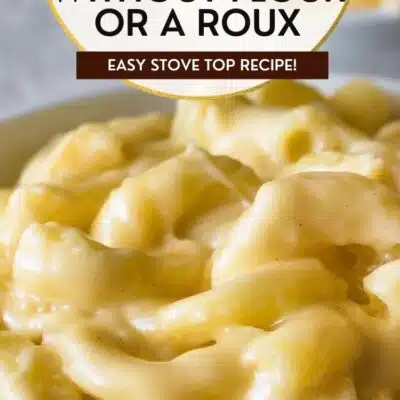 Best mac and cheese without flour recipe pin featuring a closeup on the tender pasta in creamy sauce and text title overlay.