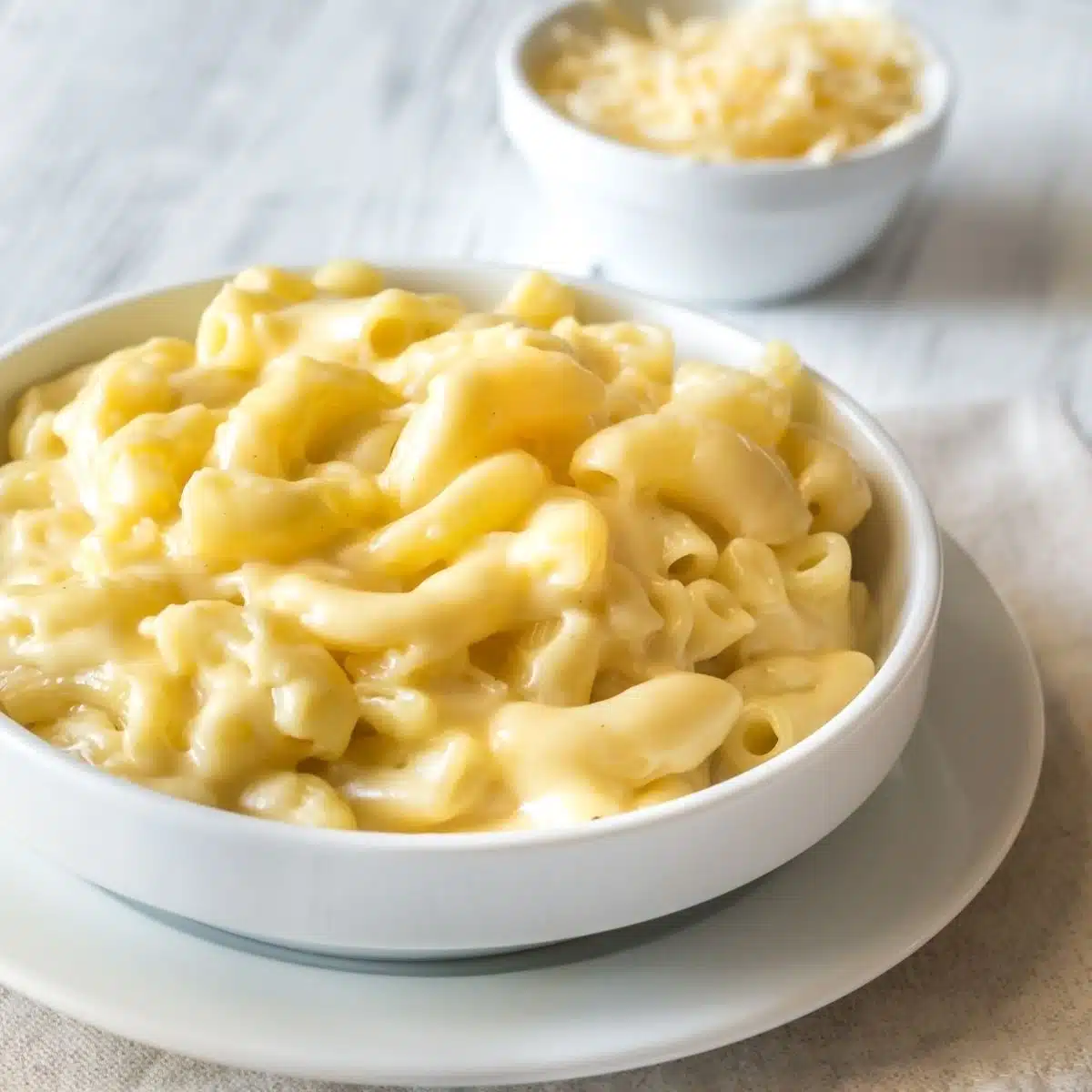 Mac and cheese without flour recipe makes creamy, delicious pasta like this hearty serving shown in a white bowl.