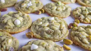 Wide closeup on the baked and cooled pistachio pudding cookies on light background.