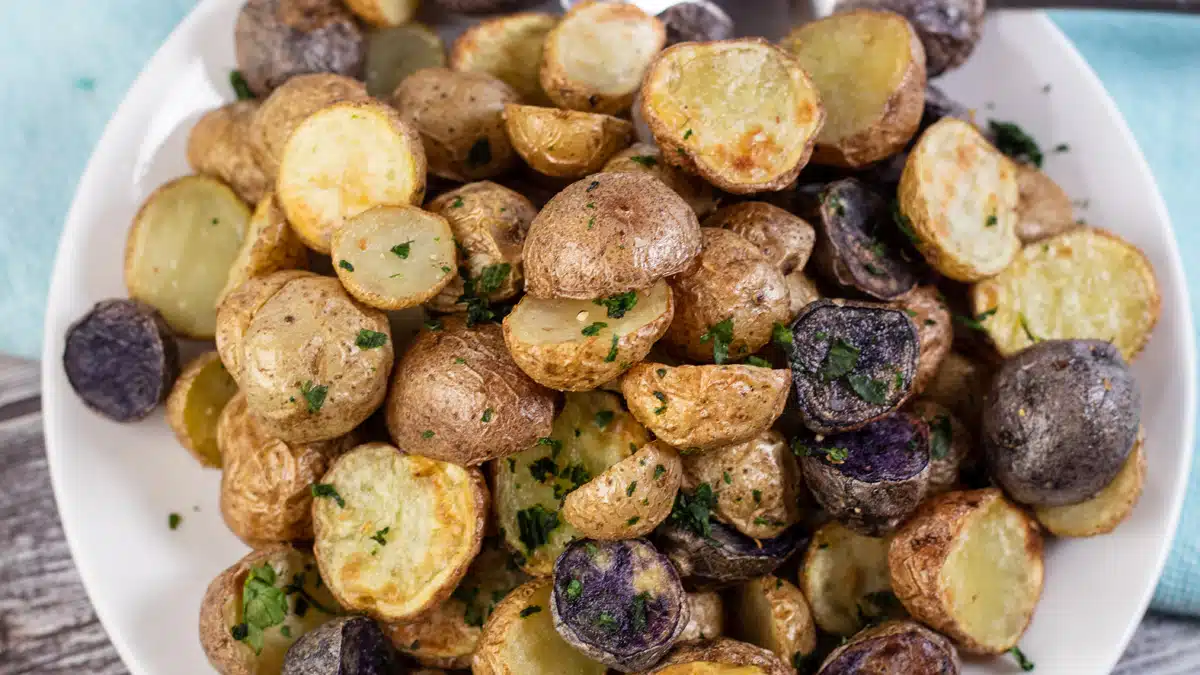 Wide close up image of a plate of air fryer baby potatoes.