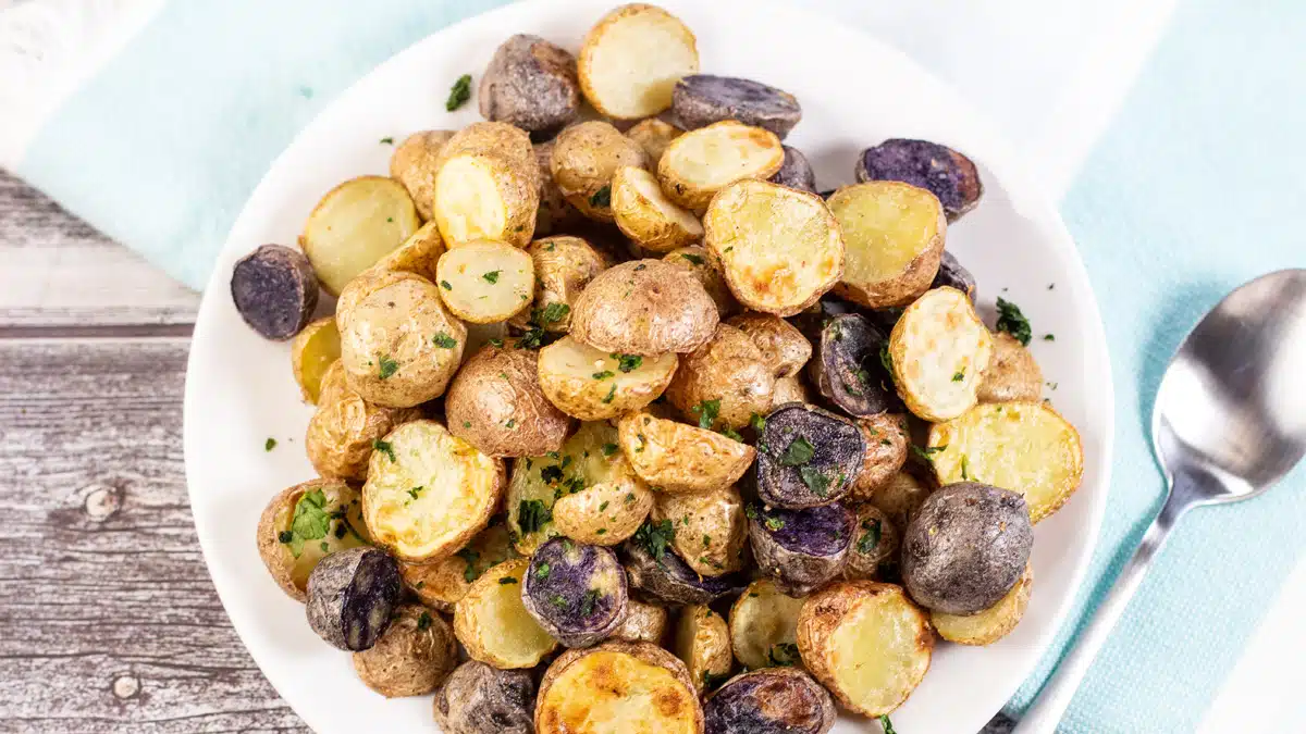 Wide image of a plate of air fryer baby potatoes.