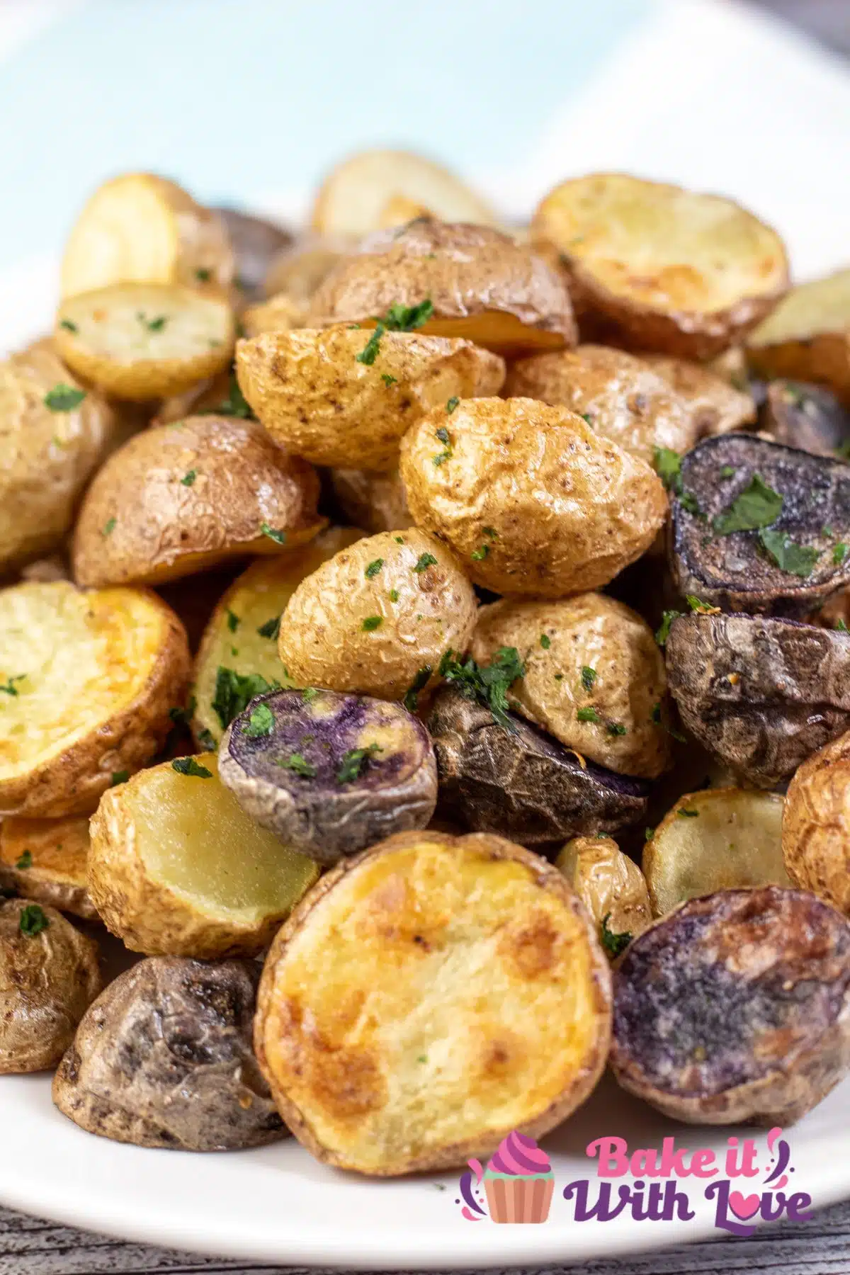 Tall image of a plate of air fryer baby potatoes.