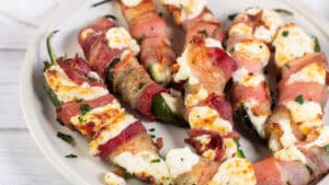 Wide image of air fried bacon wrapped jalapeno poppers.