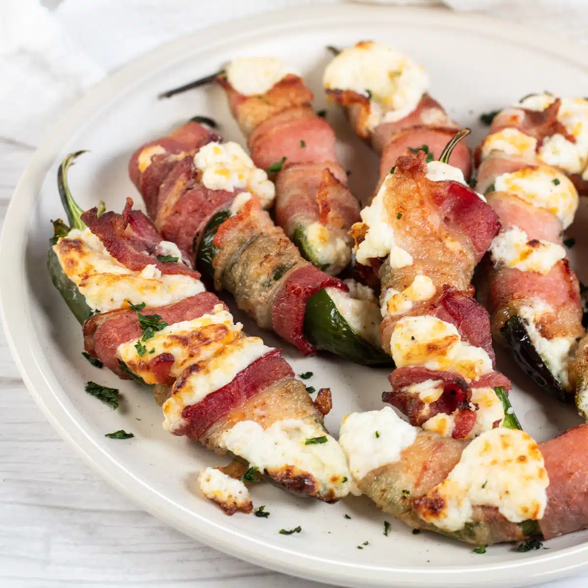 Square image of air fried bacon wrapped jalapeno poppers.