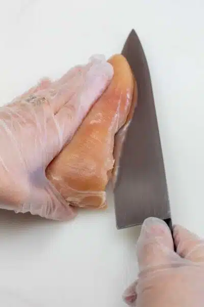 Process image 1 showing slicing chicken breasts in half.