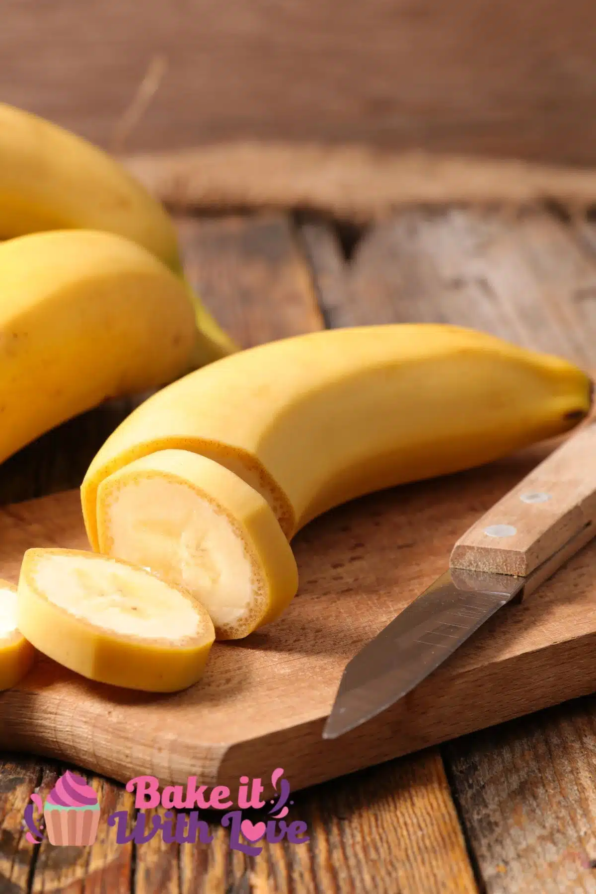 Best banana substitute featuring yellow bananas on a small cutting board with paring knife and a few pieces sliced.