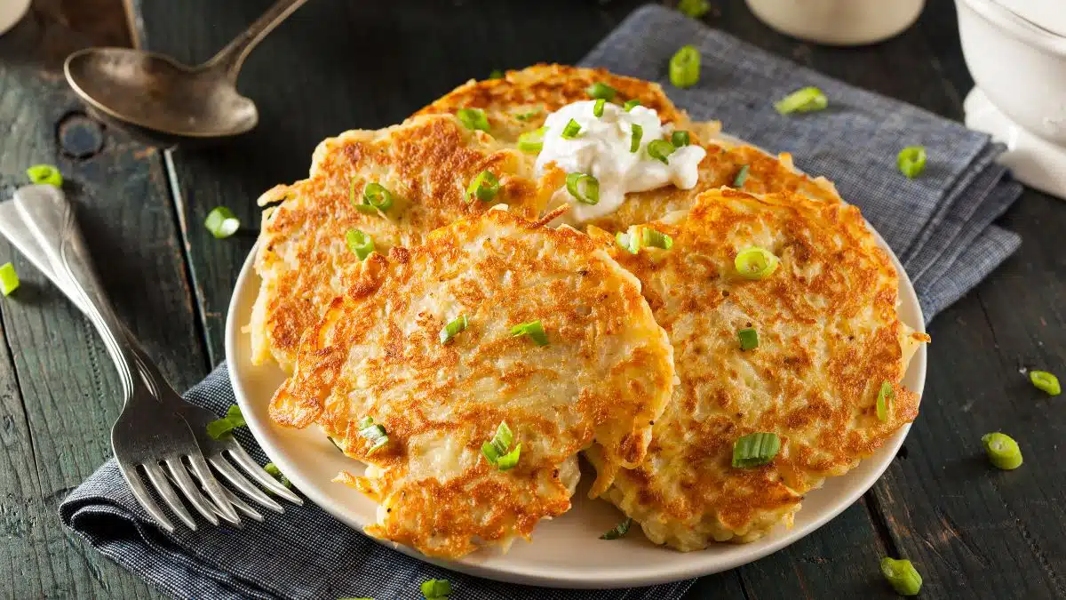 Wide image of boxty Irish pancakes on a white plate.