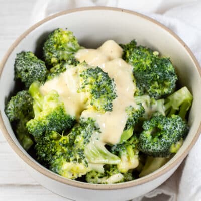 Square image showing broccoli and cheese.