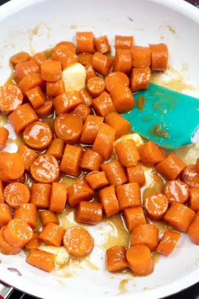 Process image 3 showing carrots with butter, seasoning, and sugar starting to melt and come together.