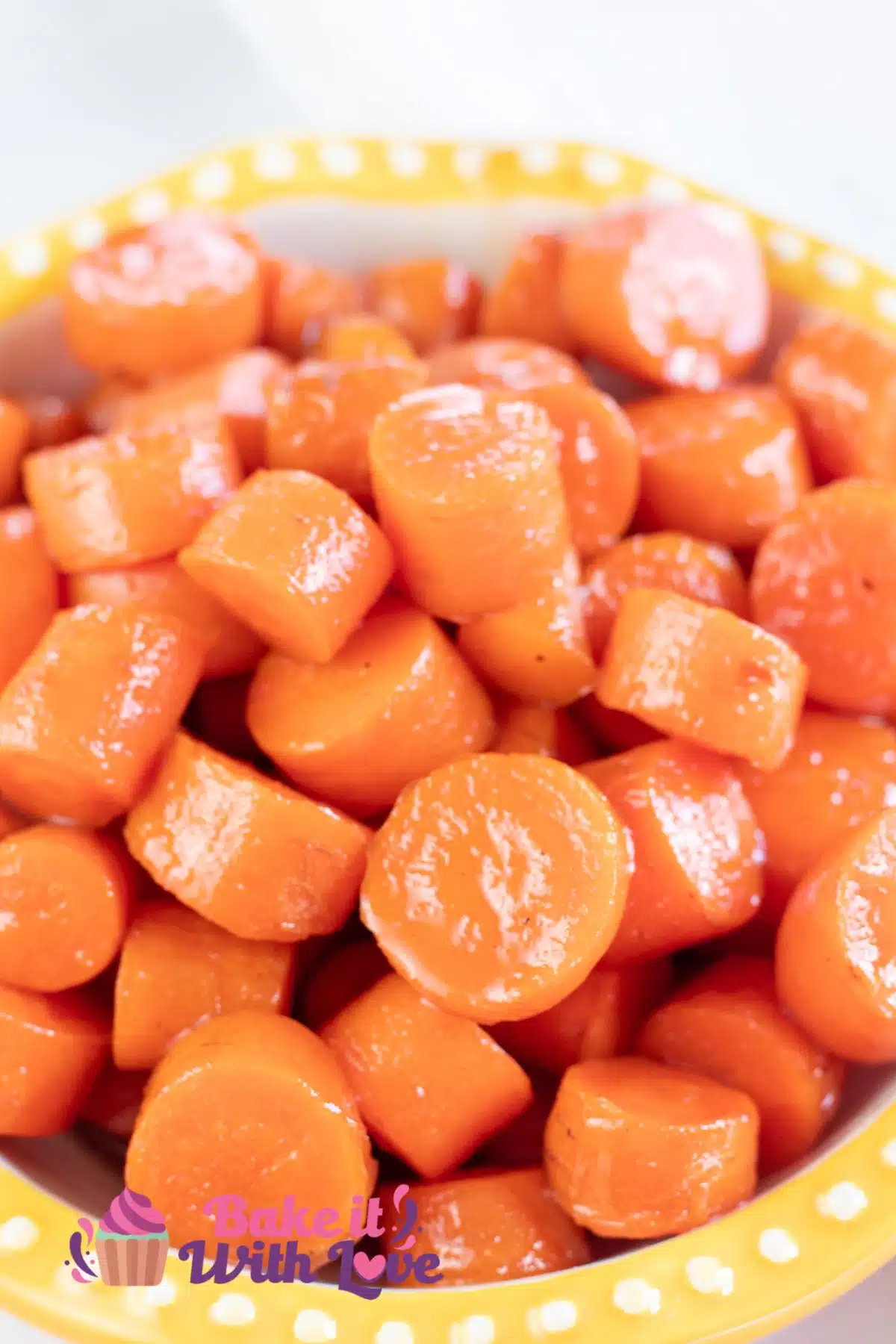 Tall image of a bowl of candied carrots.