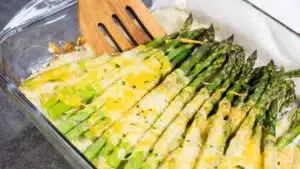 Wide image of cheesy baked asparagus.