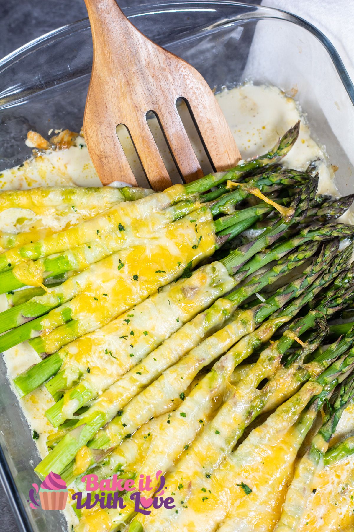 Tall image of cheesy baked asparagus.