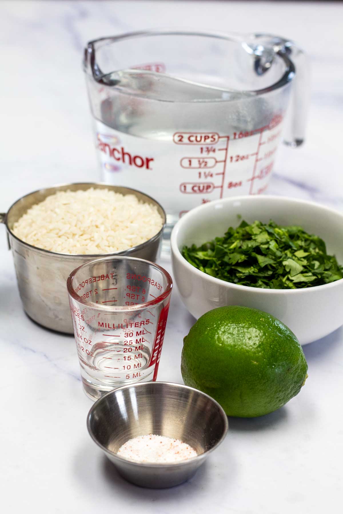 Tall image showing cilantro lime rice ingredients.