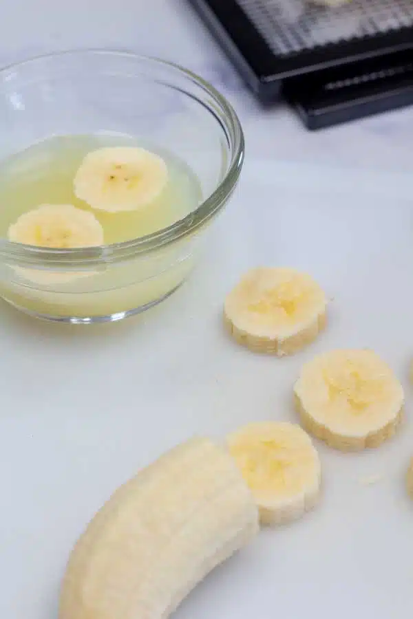 Process image 2 showing bananas in lemon juice/water.