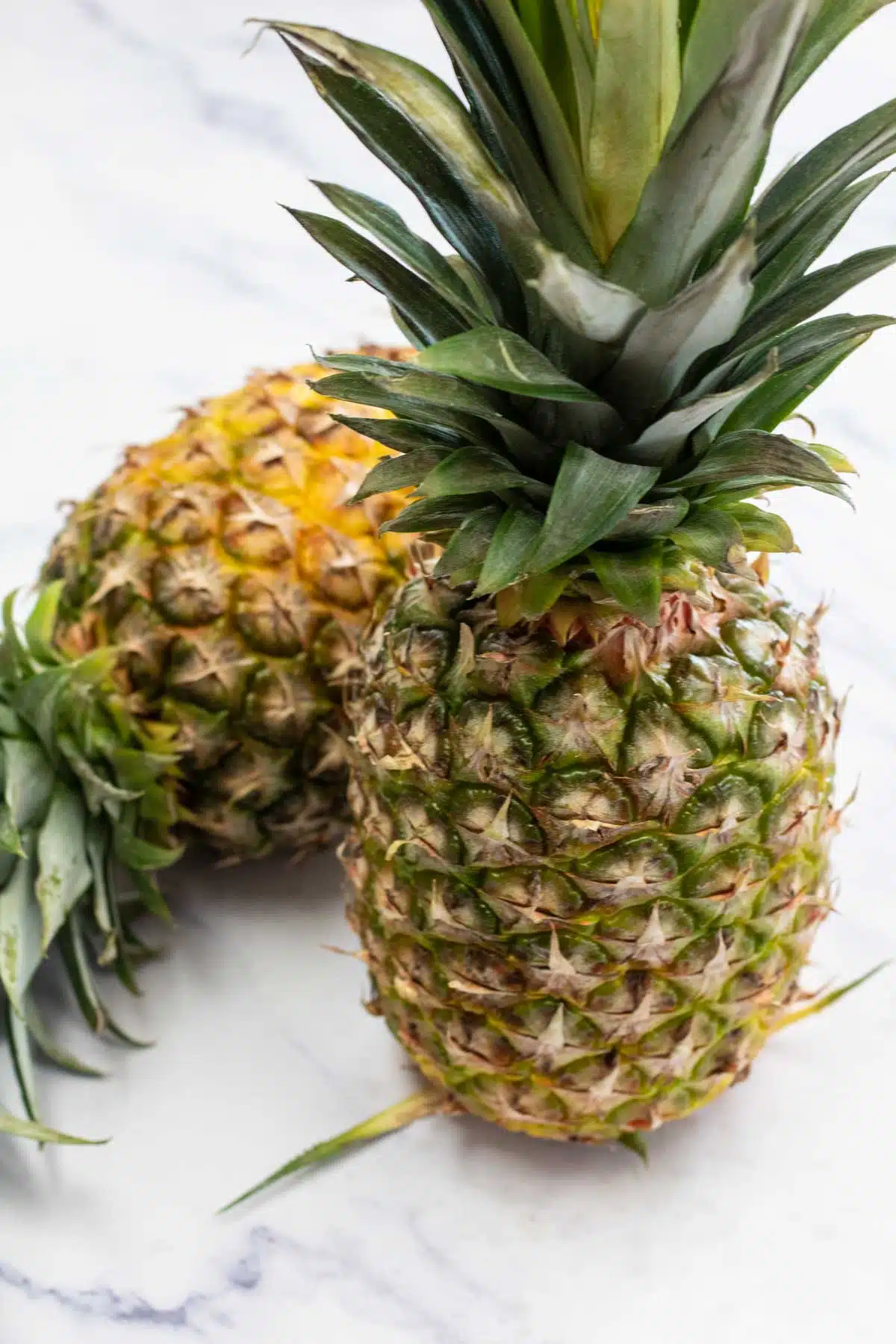 Tall image showing ingredients of pineapples.