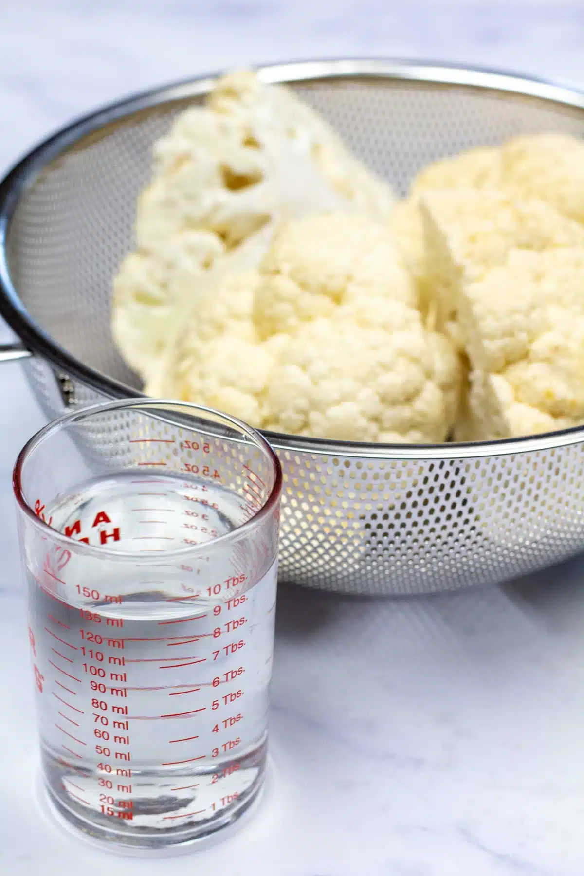 Tall image showing instant pot cauliflower ingredients.