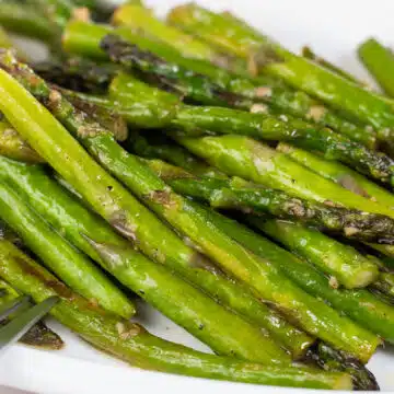 Wide image of pan fried asparagus.