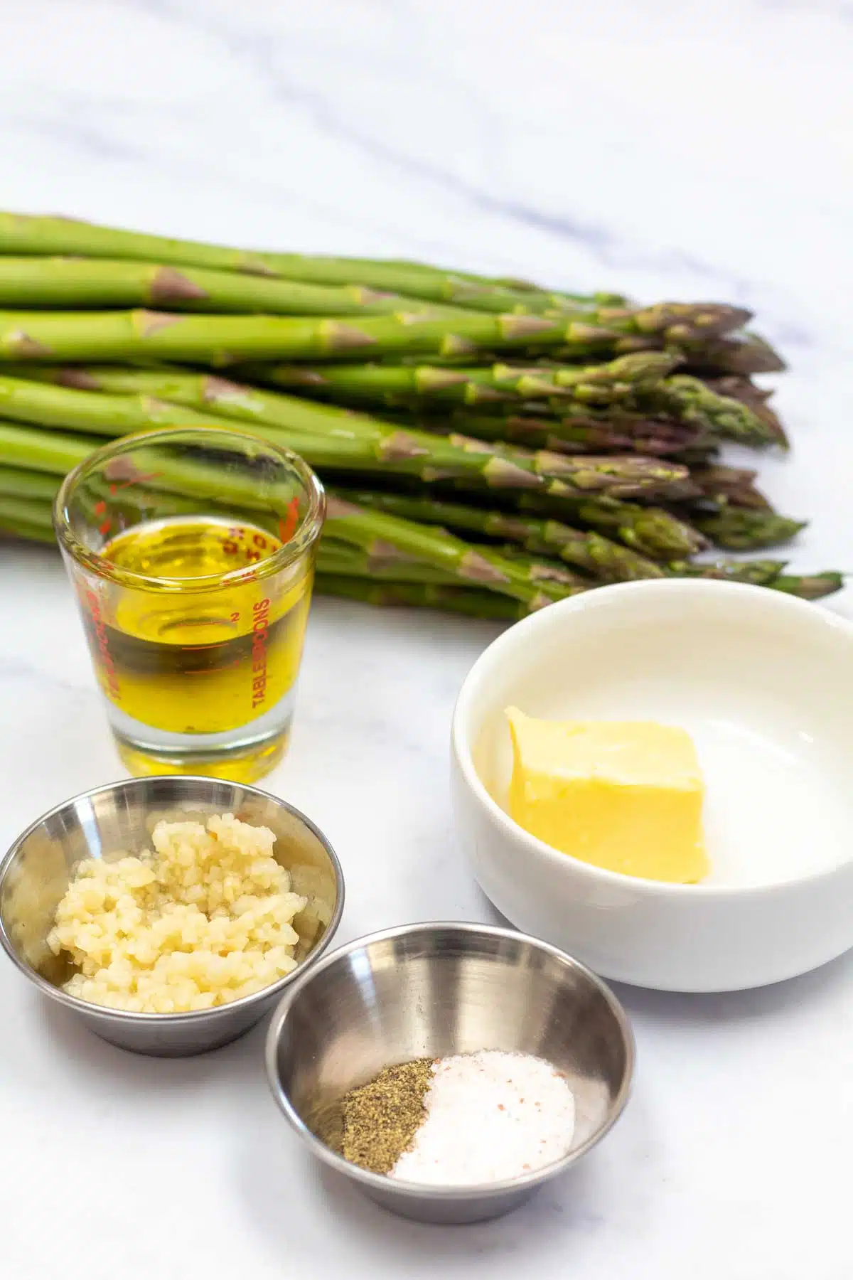 Tall image of pan fried asparagus ingredients.