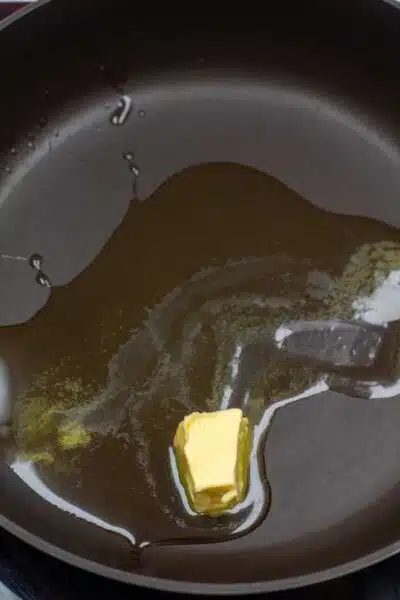 Process image showing olive oil and butter melting in a pan.