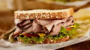 Wide image of a roast beef sandwich.