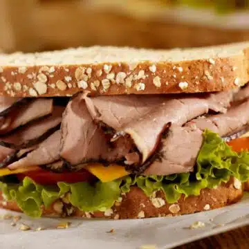 Wide image of a roast beef sandwich.