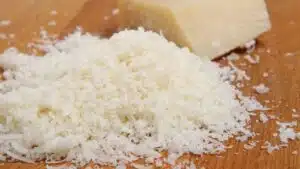Wide image of grated Romano cheese.