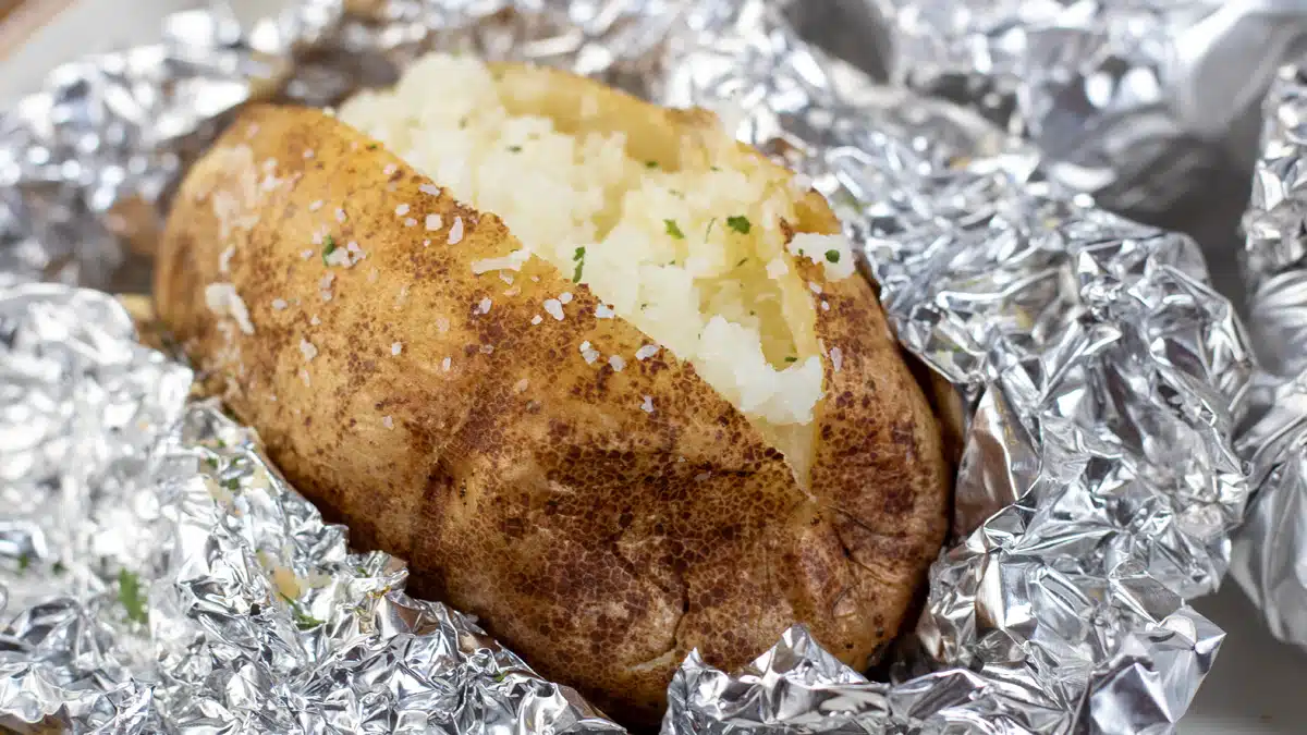 Wide image showing slow cooked baked potato.