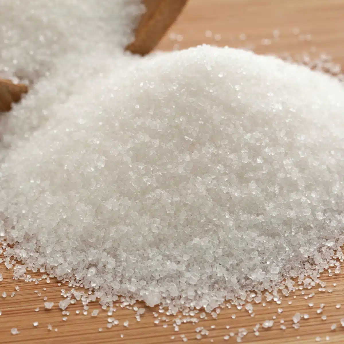 Square image of granulated white sugar.