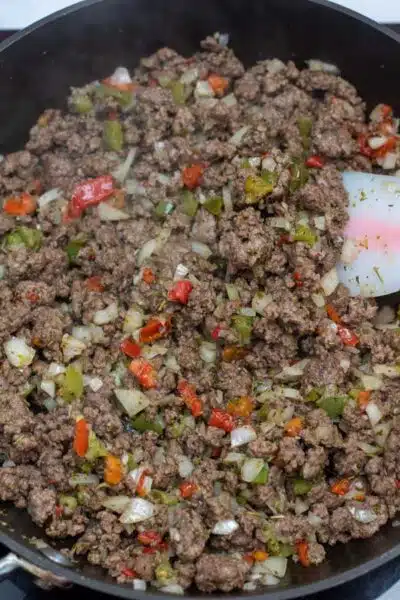 Process image 7 showing combined seasoning, onions, and peppers with browned ground beef.