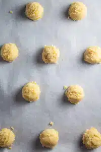 Lemon almond cookies process photo 3 dough portioned out into balls then flattened slightly before baking.