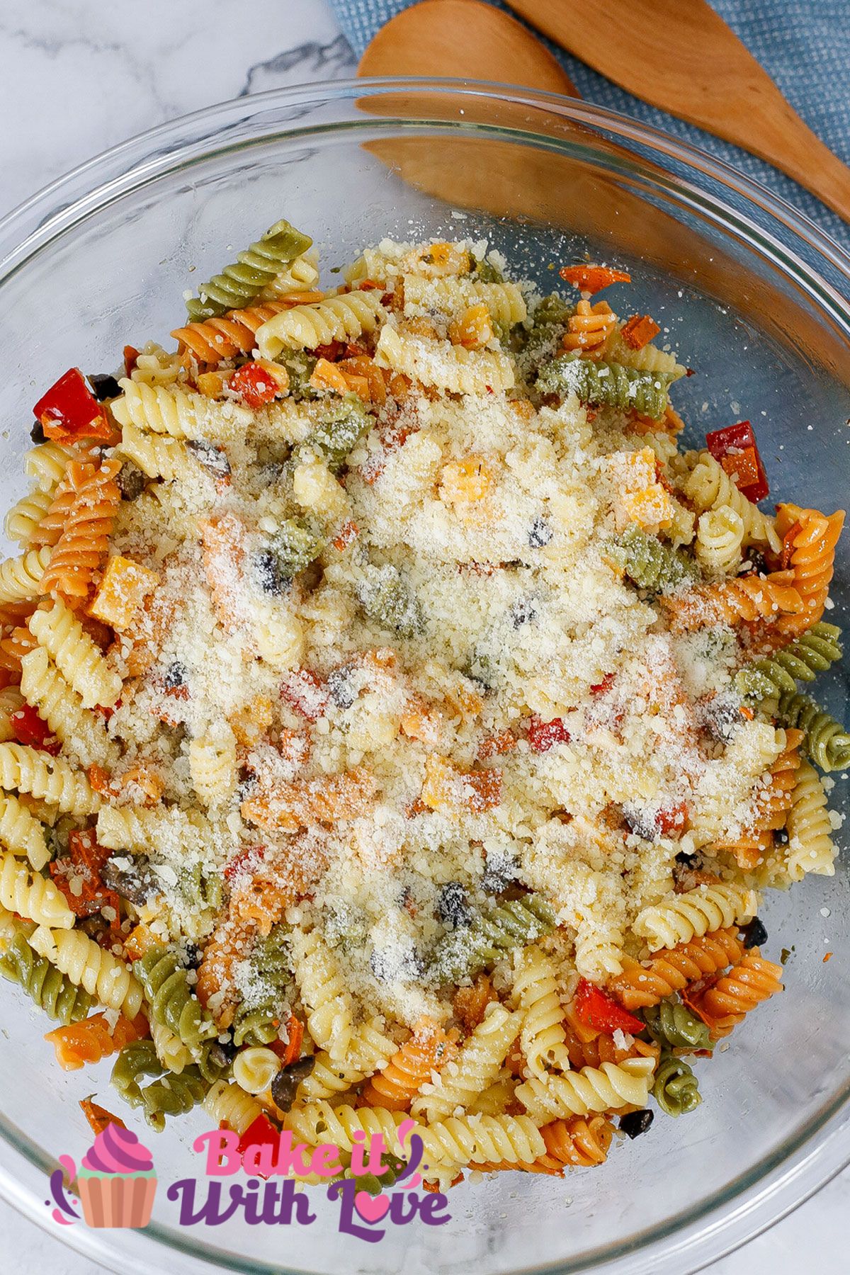 Tall image of pasta salad with Italian dressing in a white bowl.