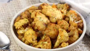 Wide image showing a bowl of air fryer cauliflower.
