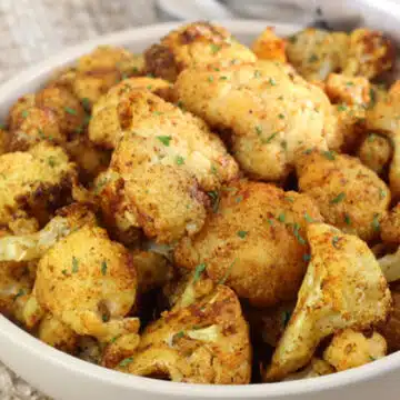 Wide image showing a bowl of air fryer cauliflower.