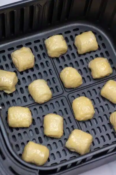 Process image 9 showing pretzel dough rolls in air fryer.