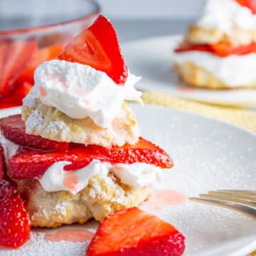 Wide image of Bisquick strawberry shortcake on a white plate.