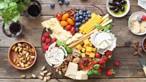 Wide image showing a cheese platter with extras.