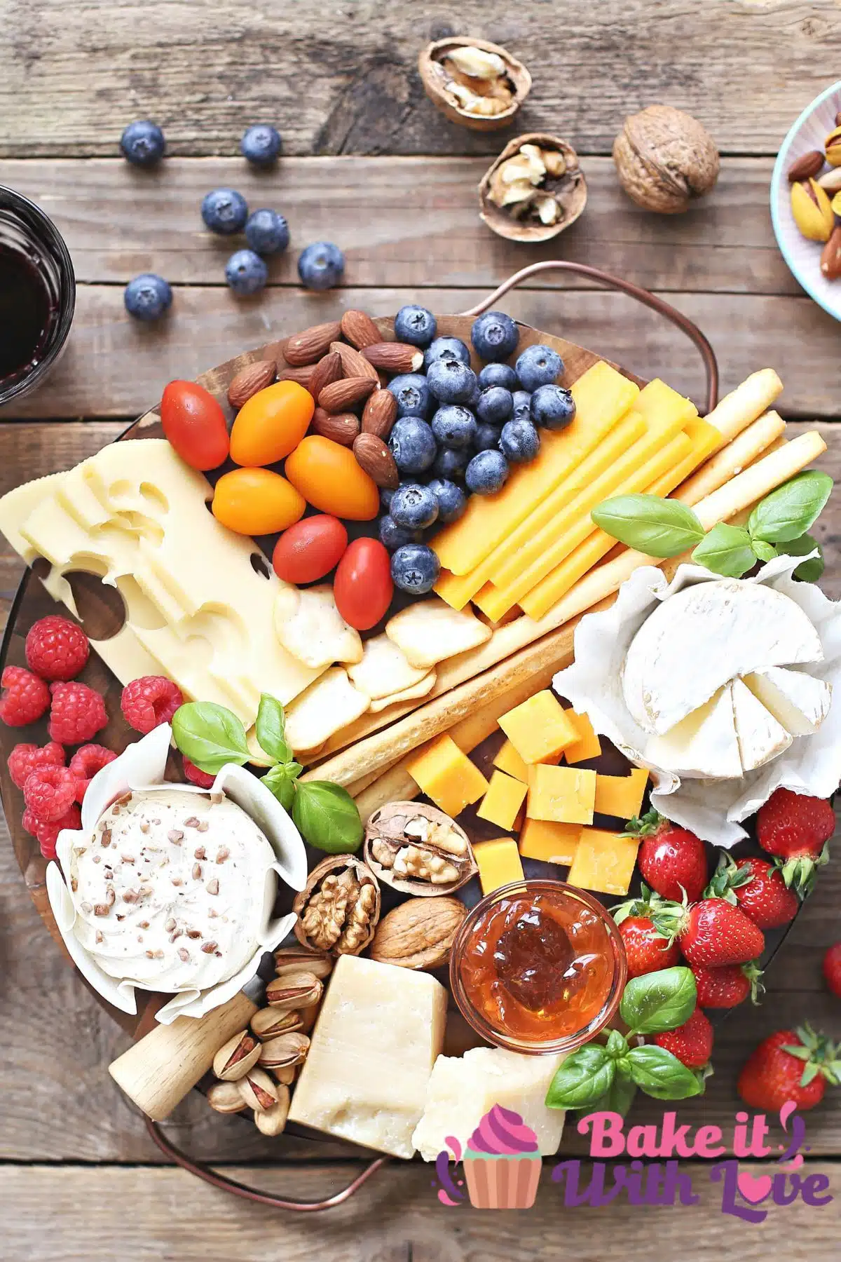Tall image showing a cheese platter with extras.