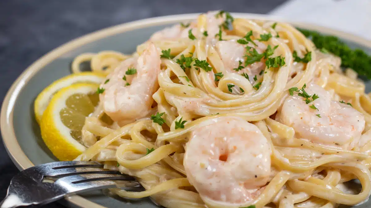 Wide image showing creamy prawn pasta.